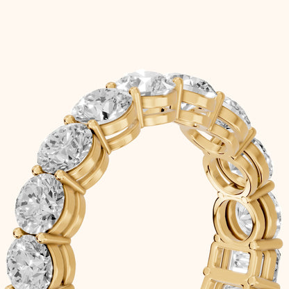 Malia Shared Prong Round & Emerald Diamond Eternity Band in Yellow Gold - slant-view