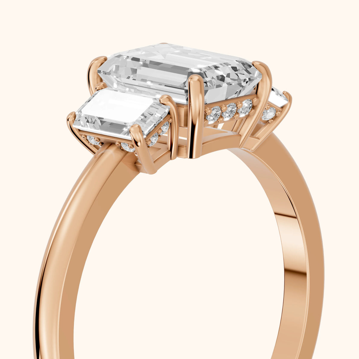 Marian Three-Stone Hidden Halo Emerald Diamond Engagement Ring in Rose Gold - slant-view.webp