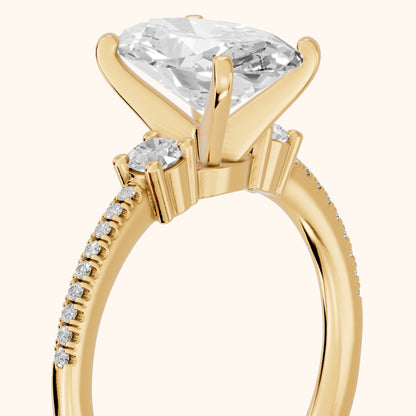 Nerissa Three-Stone Micropavé Oval Diamond Engagement Ring in Yellow Gold - slant-view.webp