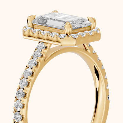 Amara Halo Claw Prong Emerald Diamond Ring in Yellow Gold - slant-view.webp
