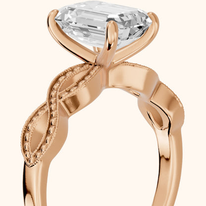Jeanie Twist Solitaire Emerald Diamond Engagement Ring in Rose Gold - slant-view.webp