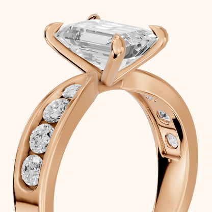 Noor Channel Set Sidestone Emerald Diamond Engagement Ring in Rose Gold - slant-view.webp