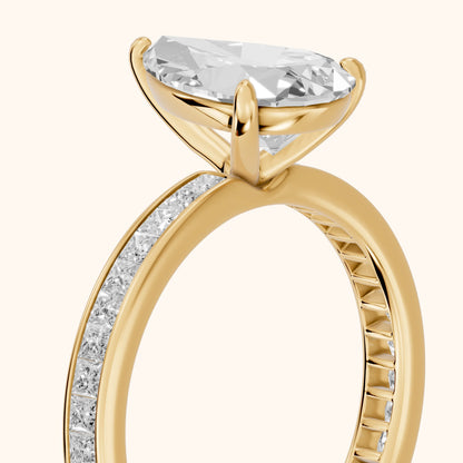 Brielle Channel Set Solitaire Pear Diamond Ring in Yellow Gold - slant-view.webp