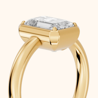 Alina Bezel Solitaire Emerald Diamond Ring in Yellow Gold - slant-view.webp
