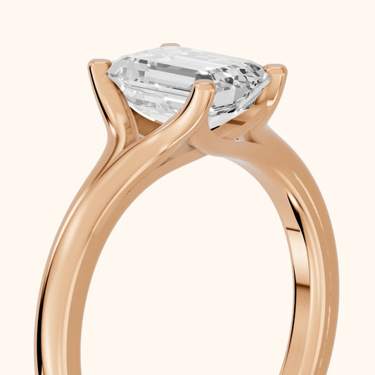 Nell Split Shank Solitaire Emerald Diamond Engagement Ring in Rose Gold - slant-view.webp