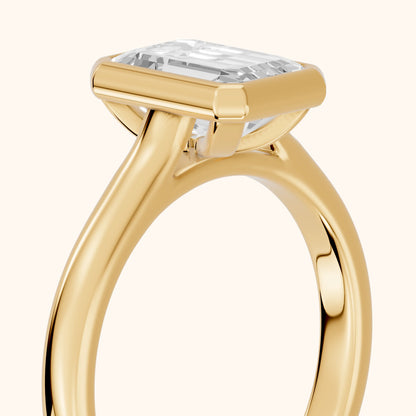 Jolie Bezel Solitaire Emerald Diamond Engagement Ring in Yellow Gold - slant-view.webp