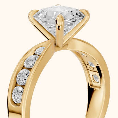 Noor Channel Set Sidestone Radiant Diamond Engagement Ring in Yellow Gold - slant-view.webp