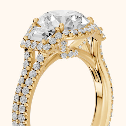 Ronan Three-Stone Halo Round Diamond Engagement Ring in Yellow Gold - slant-view.webp
