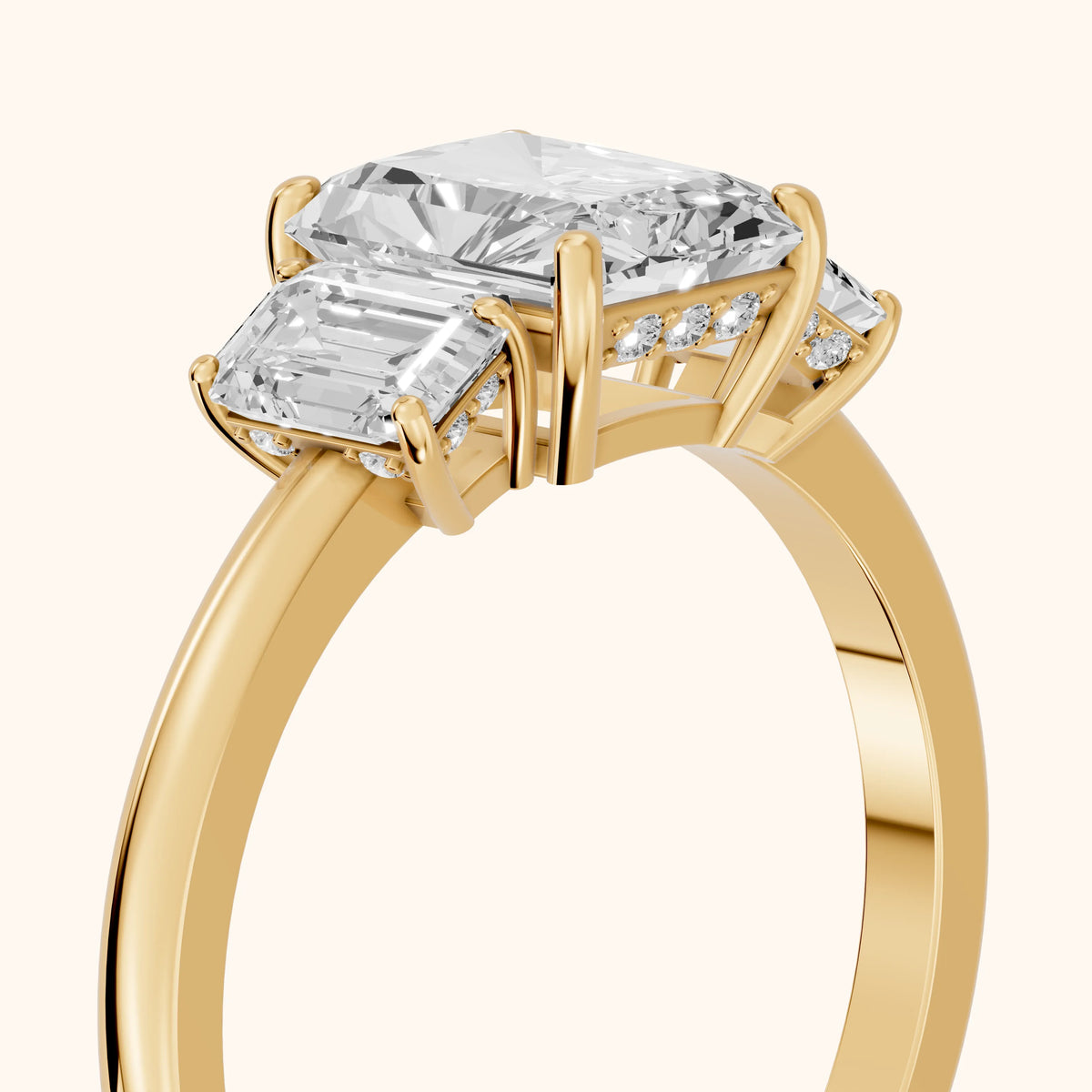 Marian Three-Stone Hidden Halo Radiant Diamond Engagement Ring in Yellow Gold - slant-view.webp