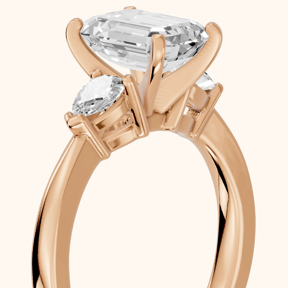 Amabel Three-Stone Emerald Diamond Engagement Ring in Rose Gold - slant-view.webp