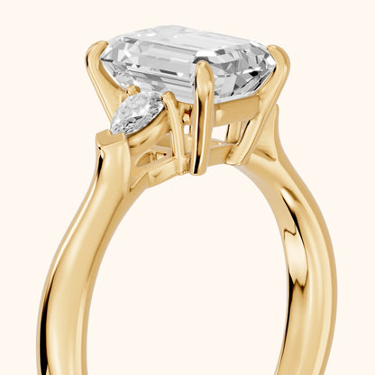 Dahlia Three-Stone Cathedral Emerald Diamond Engagement Ring in Yellow Gold - slant-view.webp