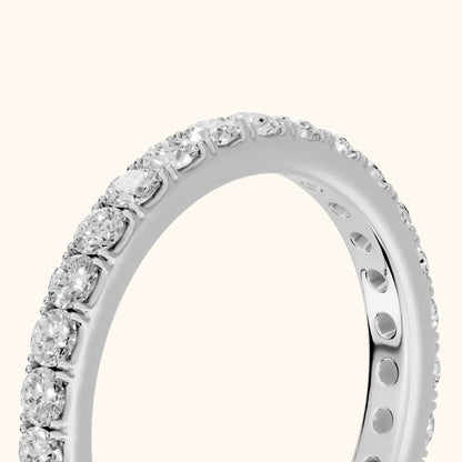 Ruhi French Pavé Round Diamond Eternity Band in Platinum - slant-view