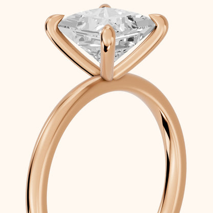Nella Petite Solitaire Princess Diamond Engagement Ring in Rose Gold - slant-view.webp