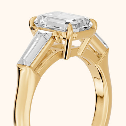 Davina Baguette Three-Stone Emerald Diamond Engagement Ring in Yellow Gold - slant-view.webp