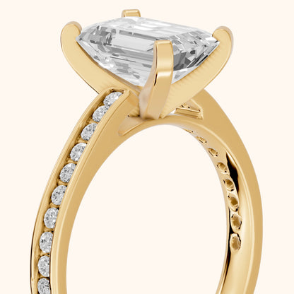 Tessa Solitaire Channel Set Emerald Diamond Engagement Ring in Yellow Gold - slant-view.webp