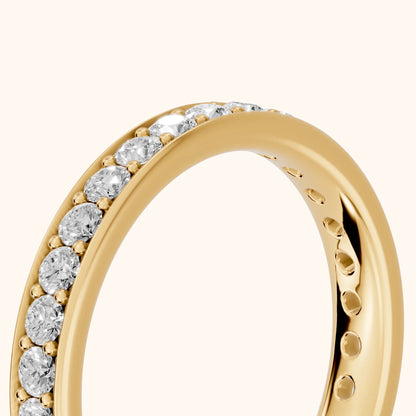 Constance Channel Set Round Diamond Eternity Band in Yellow Gold - slant-view