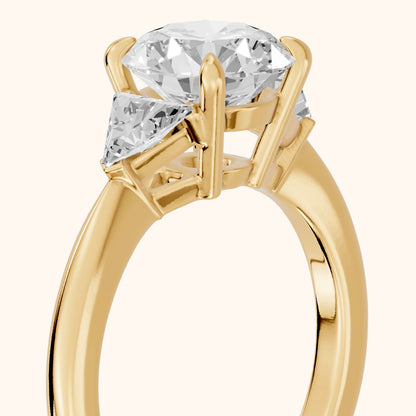 Clemency Three-Stone Cathedral Round Diamond Engagement Ring in Yellow Gold - slant-view.webp