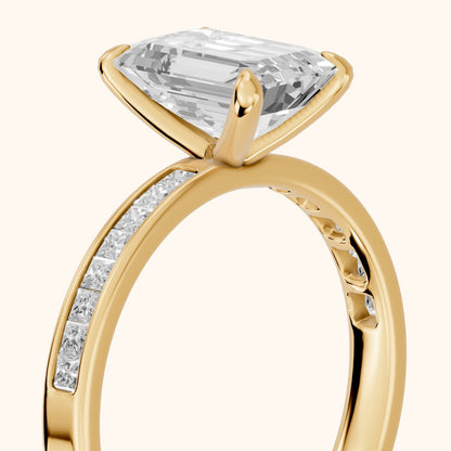 Maren Sidestone Channel Set Emerald Diamond Engagement Ring in Yellow Gold - slant-view.webp
