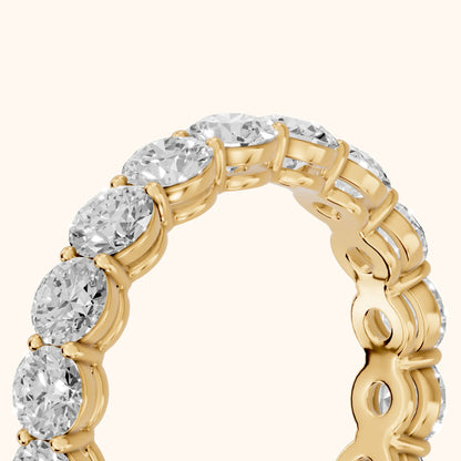 Dara Shared Prong Round Diamond Eternity Band in Yellow Gold - slant-view