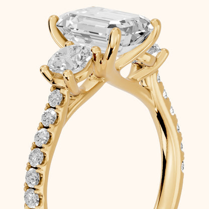 Sibyl Trellis Three-Stone Emerald Diamond Engagement Ring in Yellow Gold - slant-view.webp