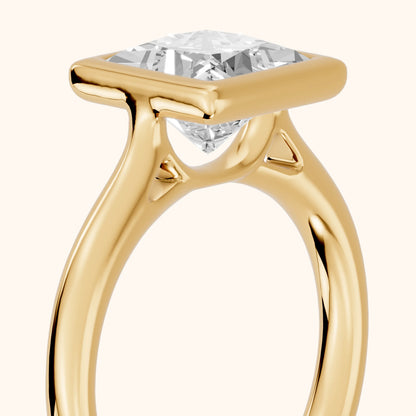 Isla Bezel Solitaire Princess Diamond Engagement Ring in Yellow Gold - slant-view.webp