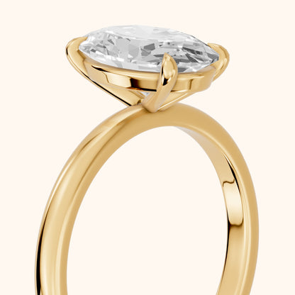 Lyla Petite Solitaire Oval Diamond Engagement Ring in Yellow Gold - slant-view.webp