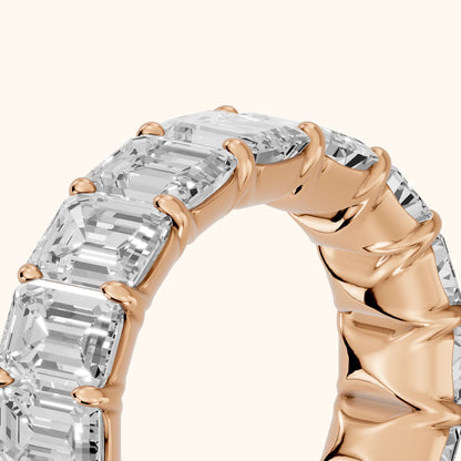 Zia Shared Prong Emerald Diamond Eternity Band in Rose Gold - slant-view