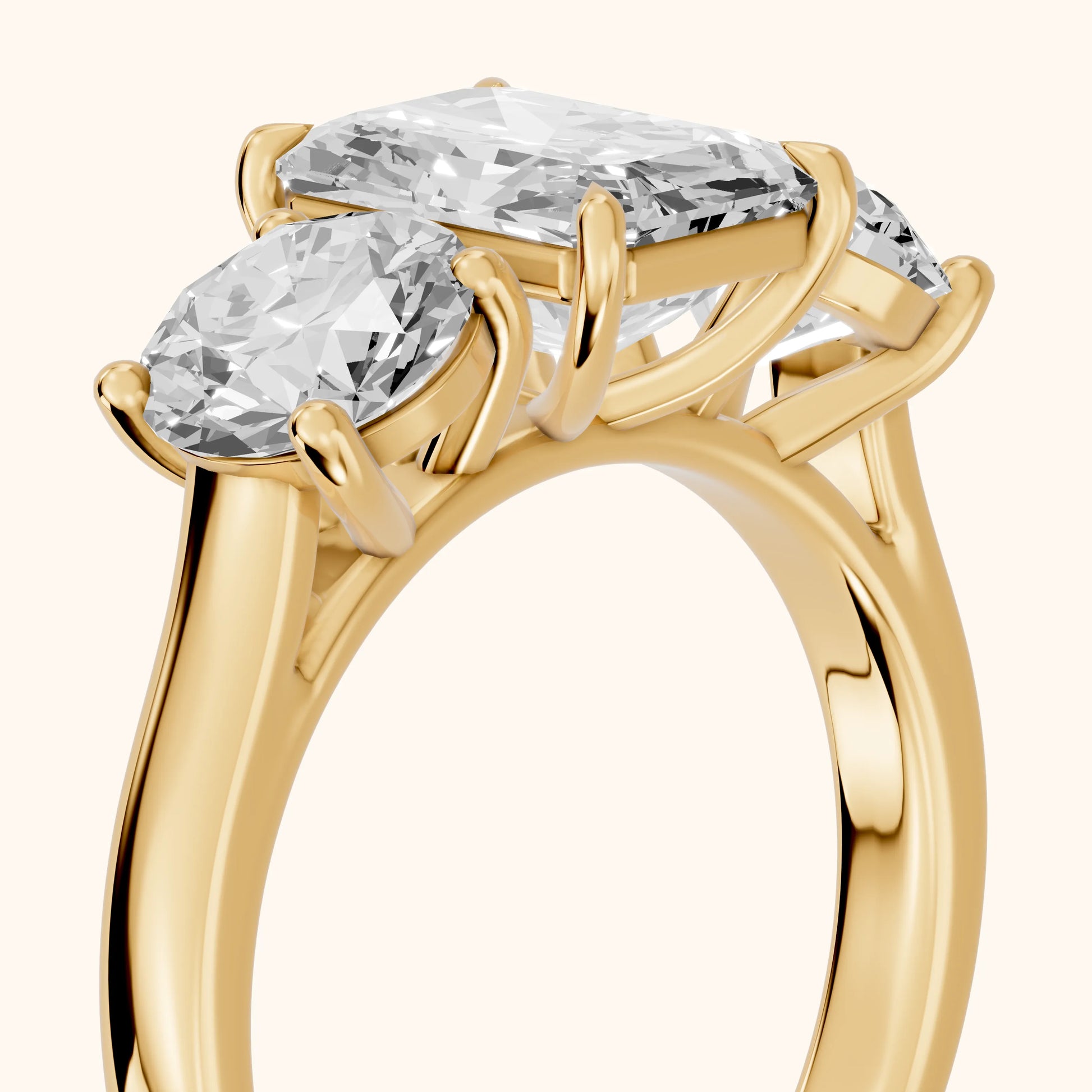 Esme Three-Stone Tapered Emerald Diamond Ring in Yellow Gold - slant-view.webp