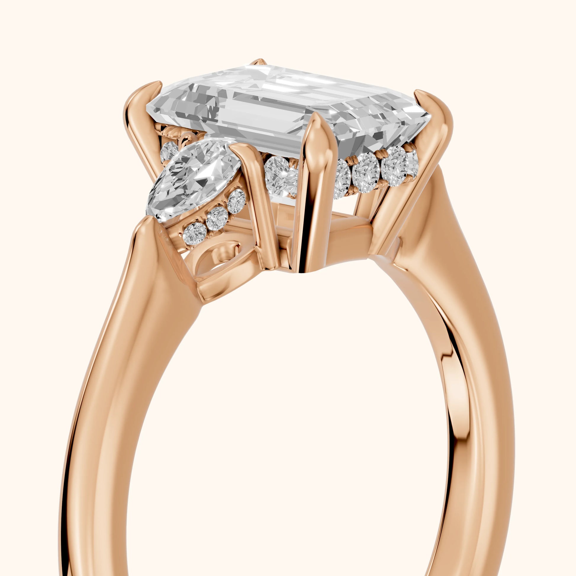 Leila Three-Stone Emerald Diamond Engagement Ring in Rose Gold - slant-view.webp