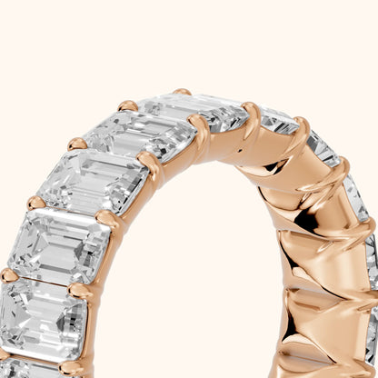 Zaya Shared Prong Emerald Diamond Eternity Band in Rose Gold - slant-view
