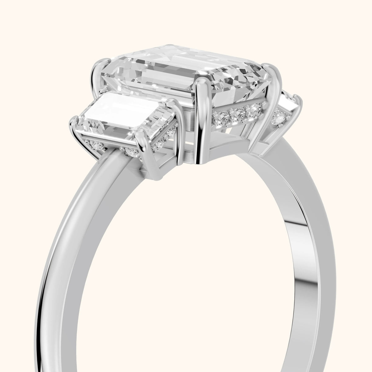 Marian Three-Stone Hidden Halo Emerald Diamond Engagement Ring in Platinum - slant-view.webp