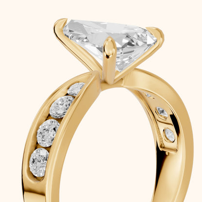 Noor Channel Set Sidestone Pear Diamond Engagement Ring in Yellow Gold - slant-view.webp