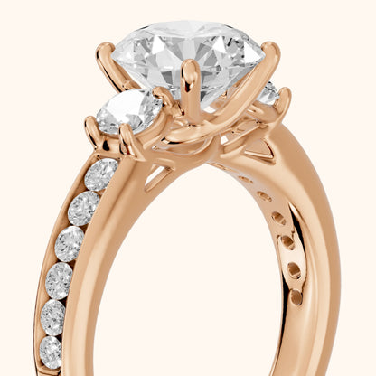Bluebell Three-Stone Channel Set Round Diamond Engagement Ring in Rose Gold - slant-view.webp