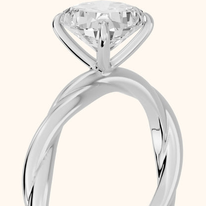 Nicola Twist Solitaire Cushion Diamond Engagement Ring in Platinum - slant-view.webp