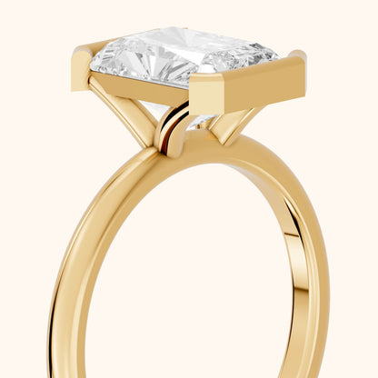 Bedford Half Bezel Solitaire Radiant Diamond Engagement Ring in Yellow Gold - slant-view.webp