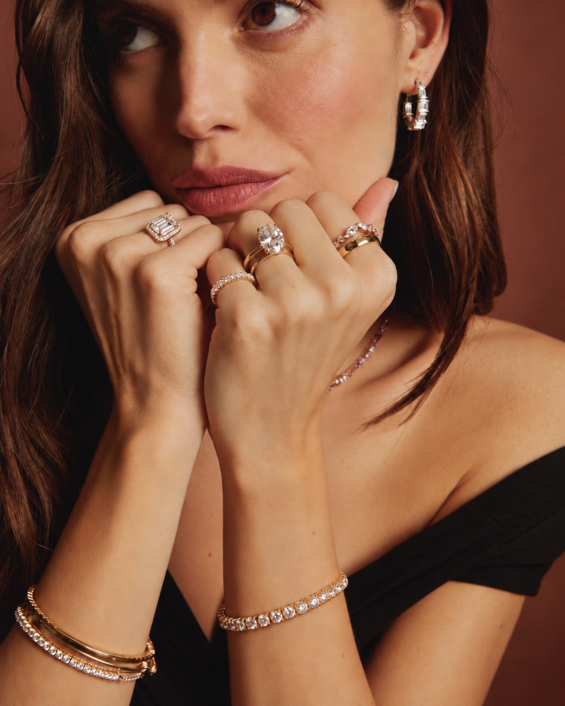 Woman wearing lab grown diamond rings, bracelets and earrings